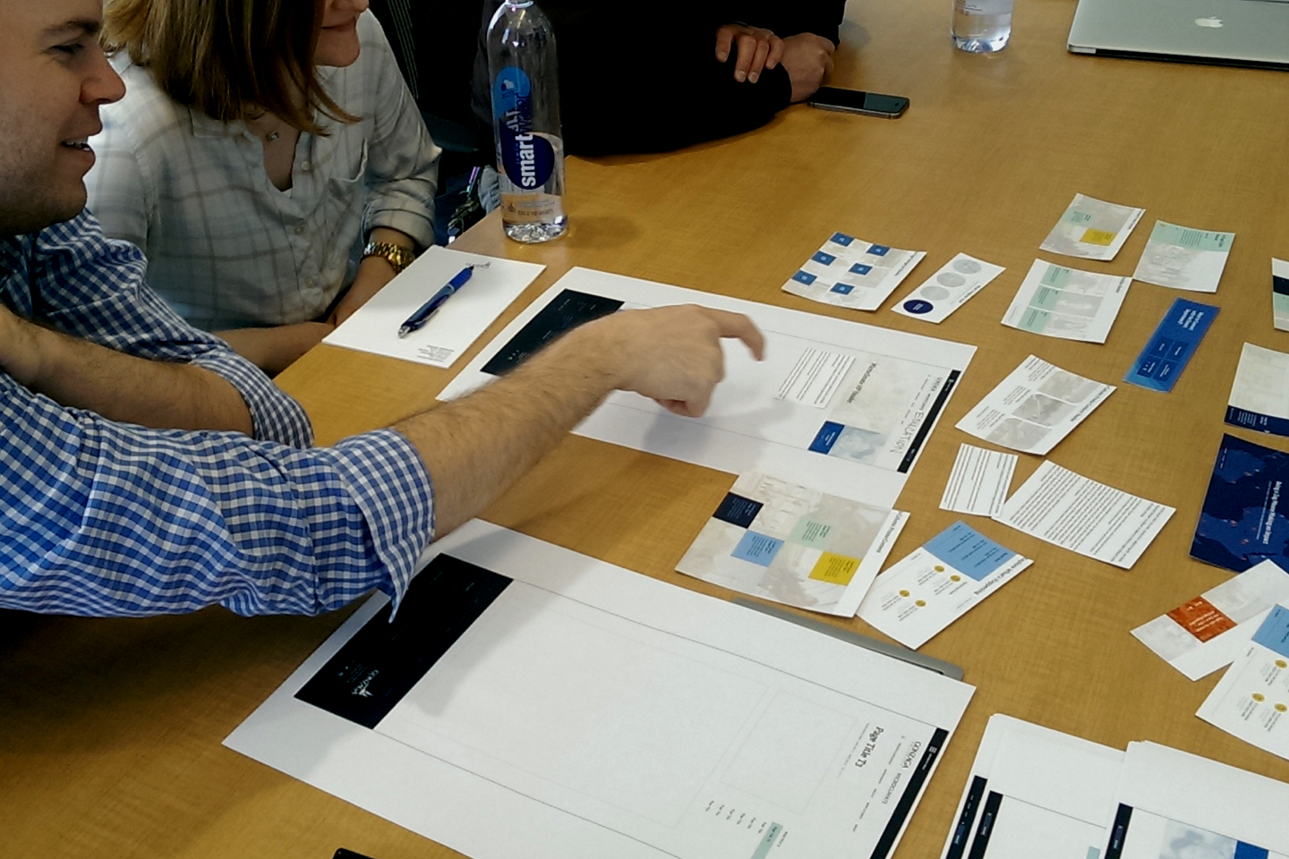 People arranging papers on a desk