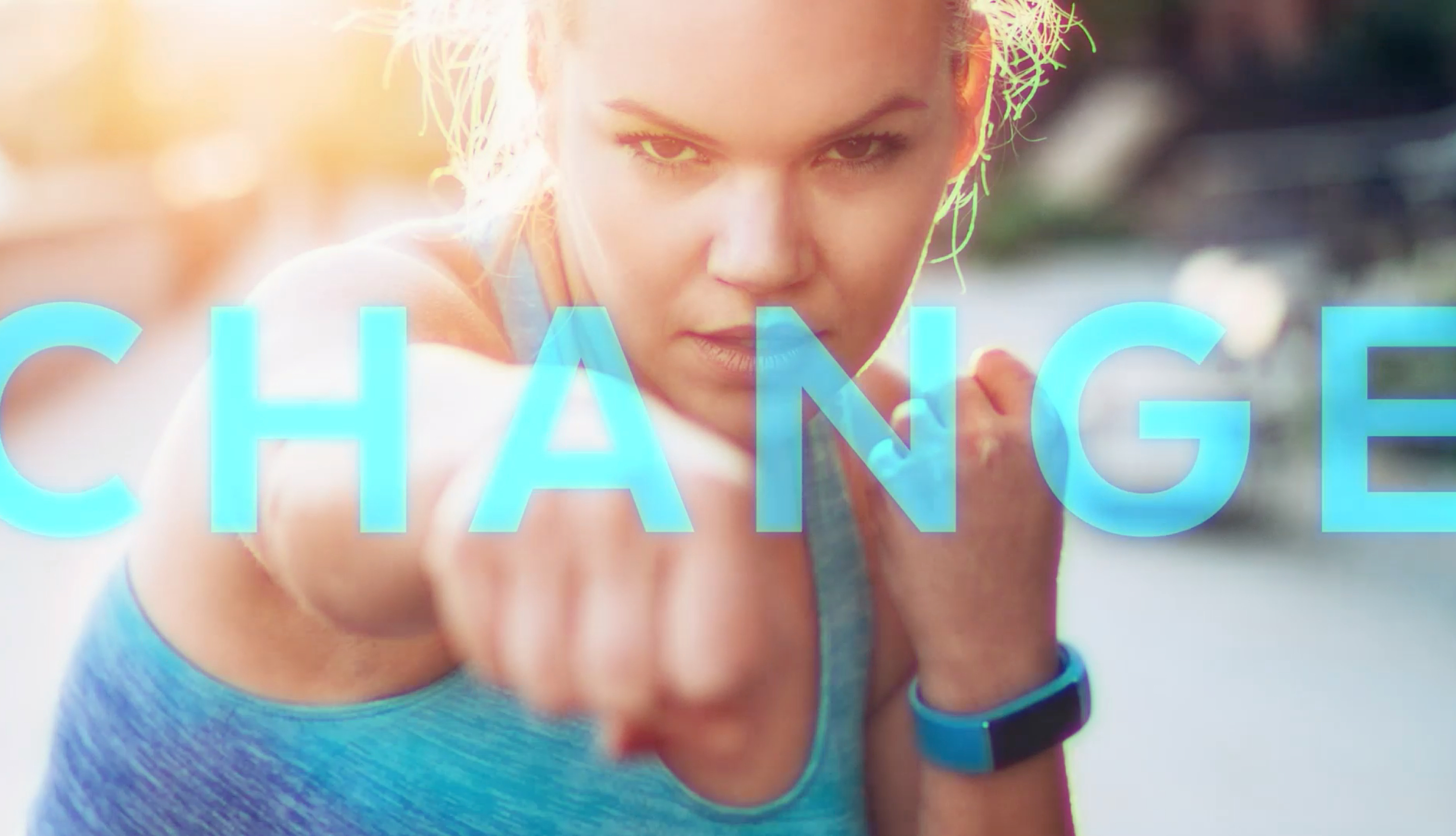 Woman kickboxing with the word Change across.