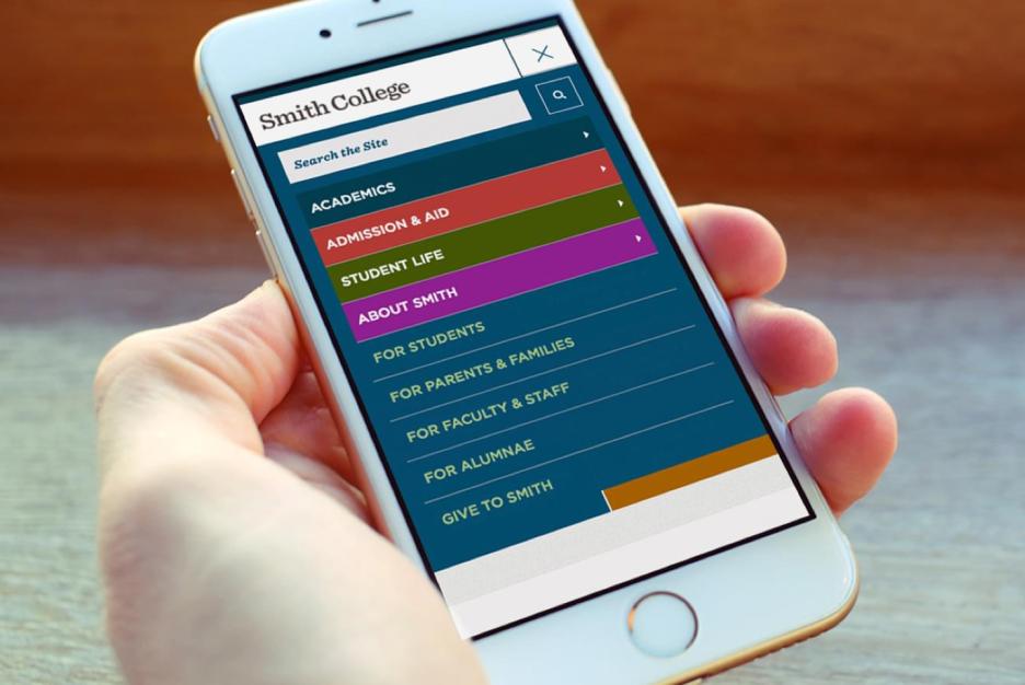 Hand holding a phone showing the Smith College mobile menu.